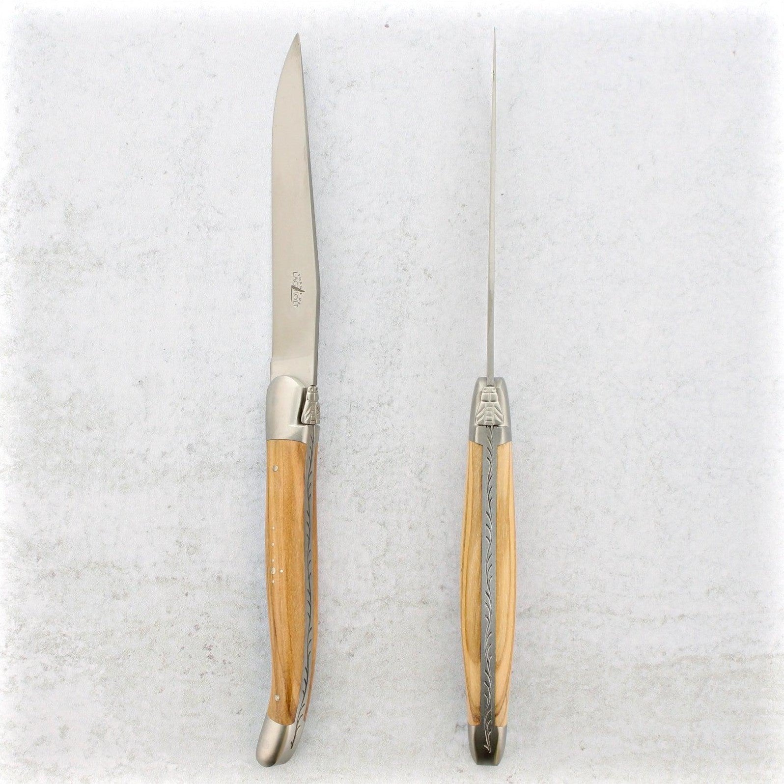 https://www.laguiole-imports.com/cdn/shop/products/Forge-de-Laguiole-Olive-Wood-Steak-Knives-Brushed-Forge-de-Laguiole-2.jpg?v=1674999057